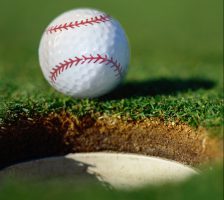 Photo of a golf ball going into the hole