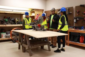 A photo of an instructor explains safety techniques to HCCTP students